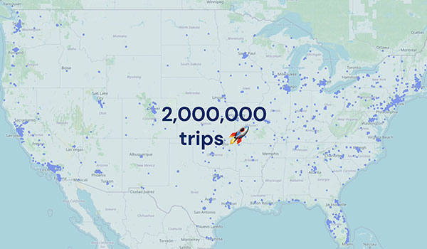 A map of the United states with purple dots representing where the oko app is being used. The text shows 2,000,000 trips with an emoji of a rocket.