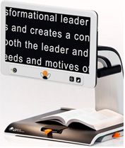 Photo of the MagnaLink Vision Video Magnifier in action displaying the words of a book in large, crisp letters on its screen.